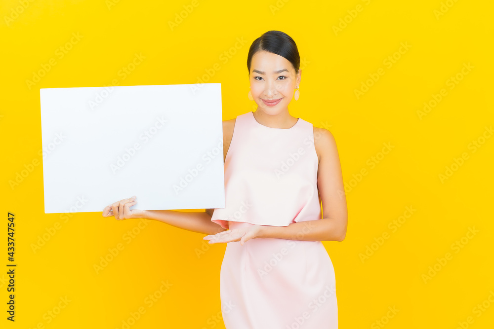 Portrait beautiful young asian woman with empty white billboard Portrait beautiful young asian woman with empty white billboard