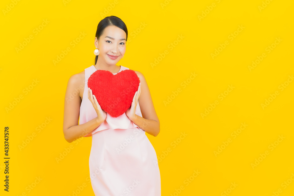 Portrait beautiful young asian woman smile with heart pillow shape Portrait beautiful young asian woman smile with heart pillow shape