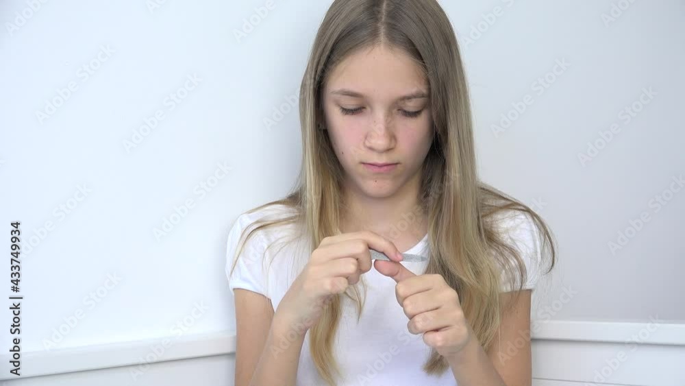 Adolescent Child Polishing Fingernails doing Manicure, Teenager Girl Cuts Nails Cuticle in Sofa, Kid Cutting Nails in Bedroom Adolescent Child Polishing Fingernails doing Manicure, Teenager Girl Cuts Nails Cuticle in Sofa, Kid Cutting Nails in Bedroom