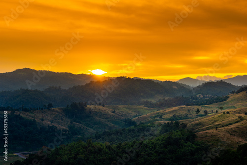 Beautiful sunrise over the mountain range at the west of thailand, nature landscape twilight background .