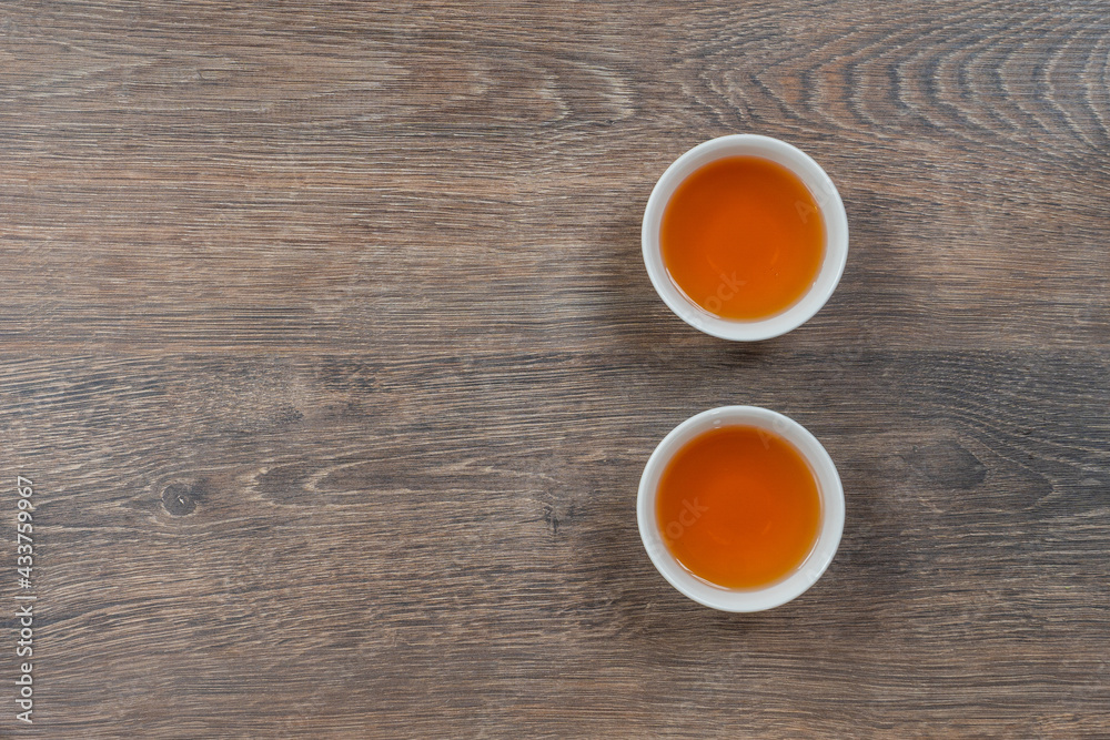 two white small tea bowls on wooden table, above minimalistic shot two white small tea bowls on wooden table, above minimalistic shot