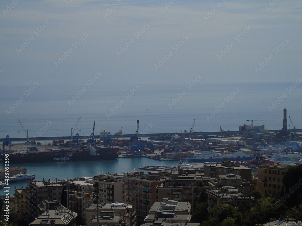 Genova, Italy - May 09, 2021: Panoramic view of the port Genoa, Italy. View from the sea to the old town, and the port on spring sunny day. Genoa bay, harbor, yacht at the pier. Tourist destinations.