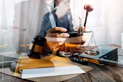 Business and lawyers discussing contract papers with brass scale on desk in office. Law, legal services, advice, justice and law concept picture with film grain effect