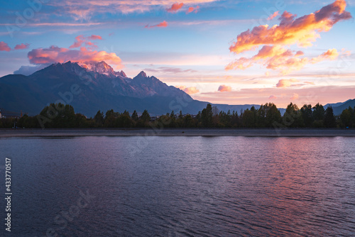 sunrise over lake and snow mountain