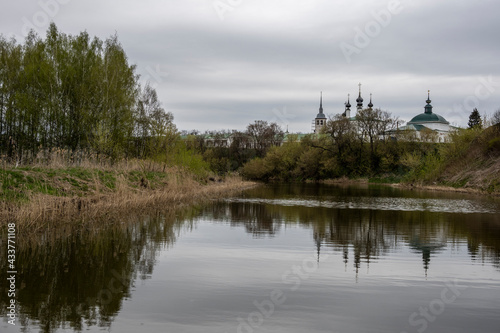 monasteries and fortresses of old Suzdal against the backdrop of a green river © константин константи
