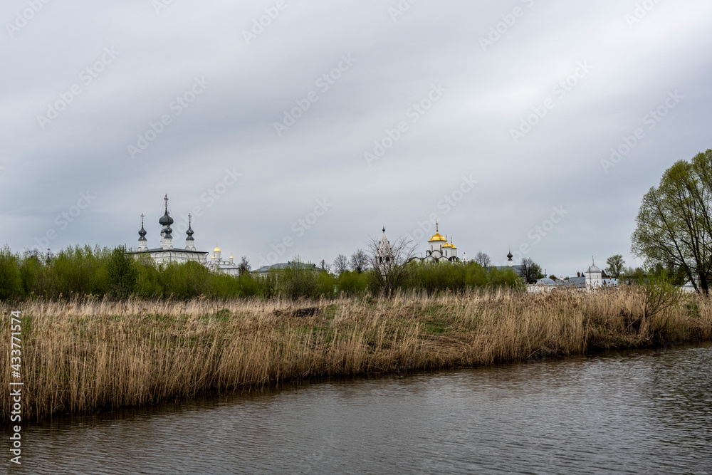 monasteries and fortresses of old Suzdal against the backdrop of a green river