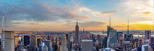 New York City skyline from roof top with urban skyscrapers at sunset. New York, USA. Panorama image.