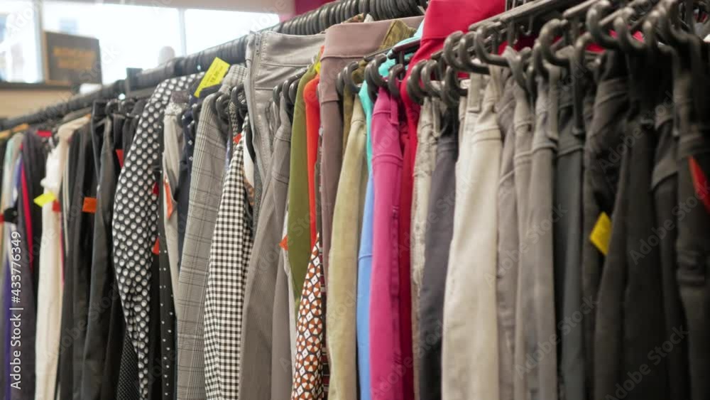 A clothing store without people. Lots of clothes on hangers. Slow motion along the rows of jeans A clothing store without people. Lots of clothes on hangers. Slow motion along the rows of jeans