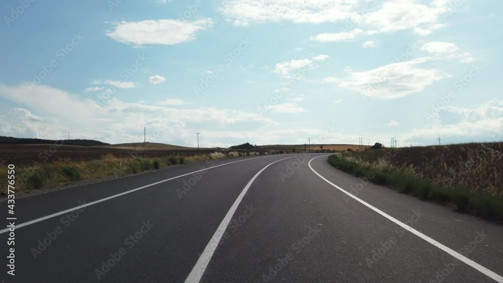 Driver POV on a empty rural road among the fields in autumn Driver POV on a empty rural road among the fields in autumn