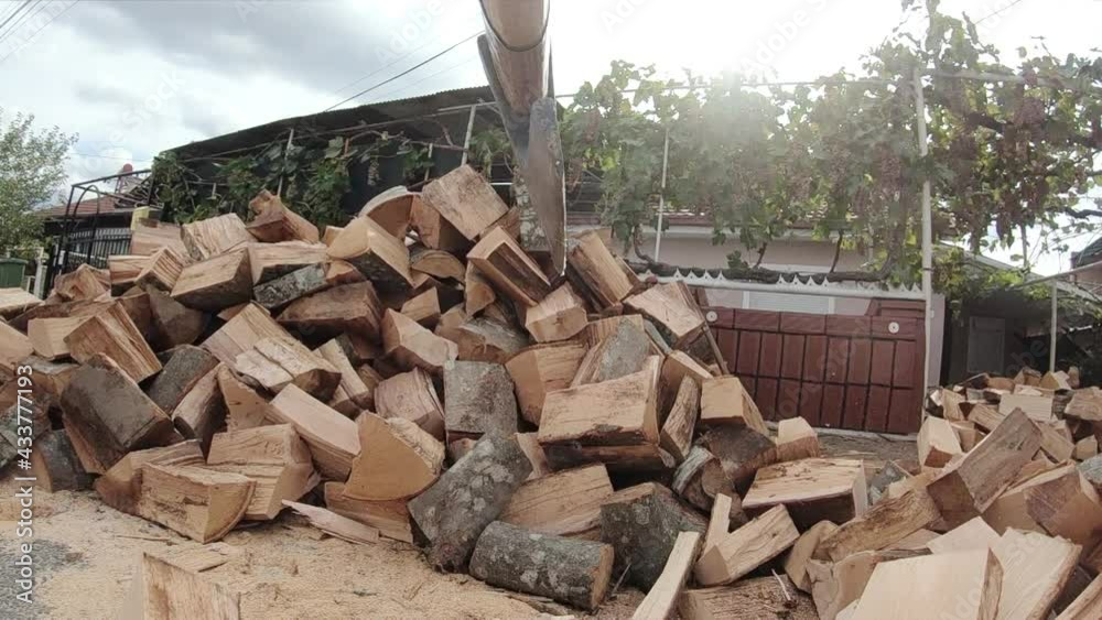 Male Lumberjack with an axe chopping a firewood int the street, preparing for winter season. Slow motion Male Lumberjack with an axe chopping a firewood int the street, preparing for winter season. Slow motion