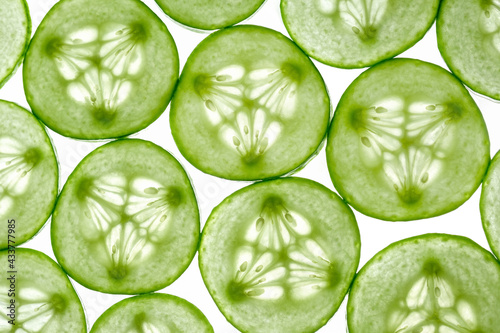 Fresh sliced cucumber slices isolated on a white background. Cucumber slices in light. Top view