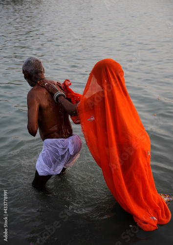 Pilgrims and Sadhus worshiping and having holy bath at Ganga river Haridwar , Uttarakhand , India.  