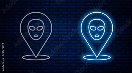 Glowing neon line Alien icon isolated on brick wall background. Extraterrestrial alien face or head symbol. Vector