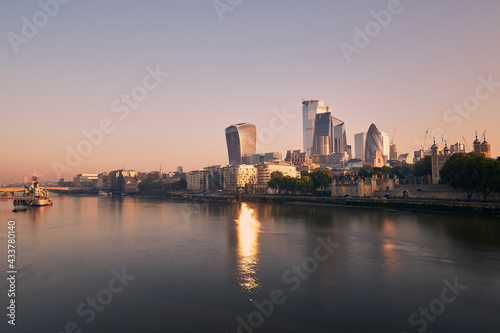 View of riverbank Thames River against skyscrapers. Urban skyline of London at morning light   United Kingdom..