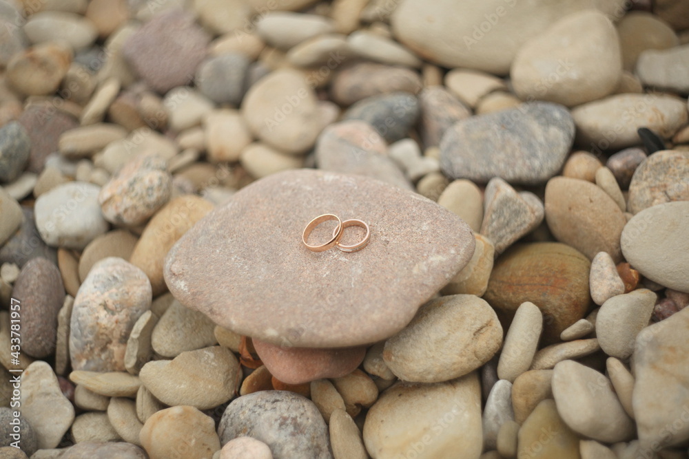 Golden wedding rings on a stones. Rustic wedding concept. Golden wedding rings on a stones. Rustic wedding concept.