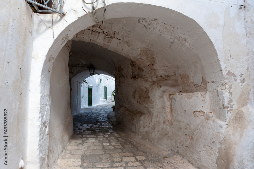 Via Alessandro Petrarolo, an ancient covered alley in the centro storico (historic centre) of Ostuni, Puglia, Southern Italy
