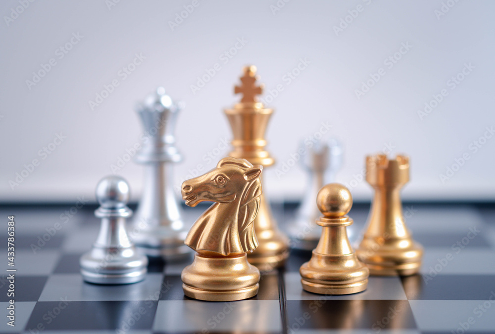 gold knight Against whithe background, International chess, ideas and competition and strategy, chess board game competition business concept. gold knight Against whithe background, International chess, ideas and competition and strategy, chess board game competition business concept.