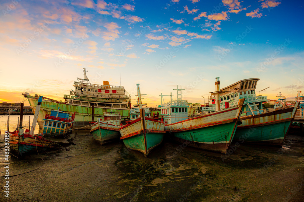 Fototapeta premium Many boats moored in sunrise morning time at Chalong port, Main port for travel ship to krabi and phi phi island, Phuket, Thailand
