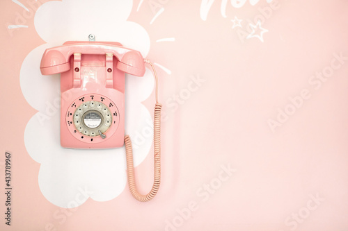A retro phone hangs on the wall in a pastry shop. Pastry shop, ambience
