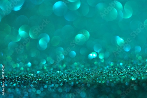 Abstract turquoise bokeh glitter on nature background