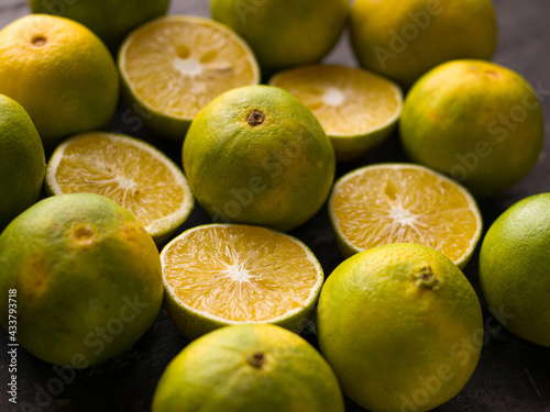 Fresh Mousambi OR Green lemon stock image on dark background. photo