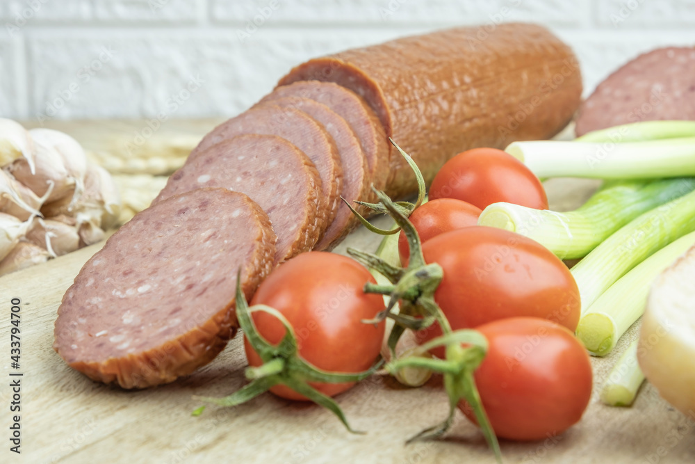 Smoked salami sausage, fresh vegetables for picnic. Food background. Smoked salami sausage, fresh vegetables for picnic. Food background.