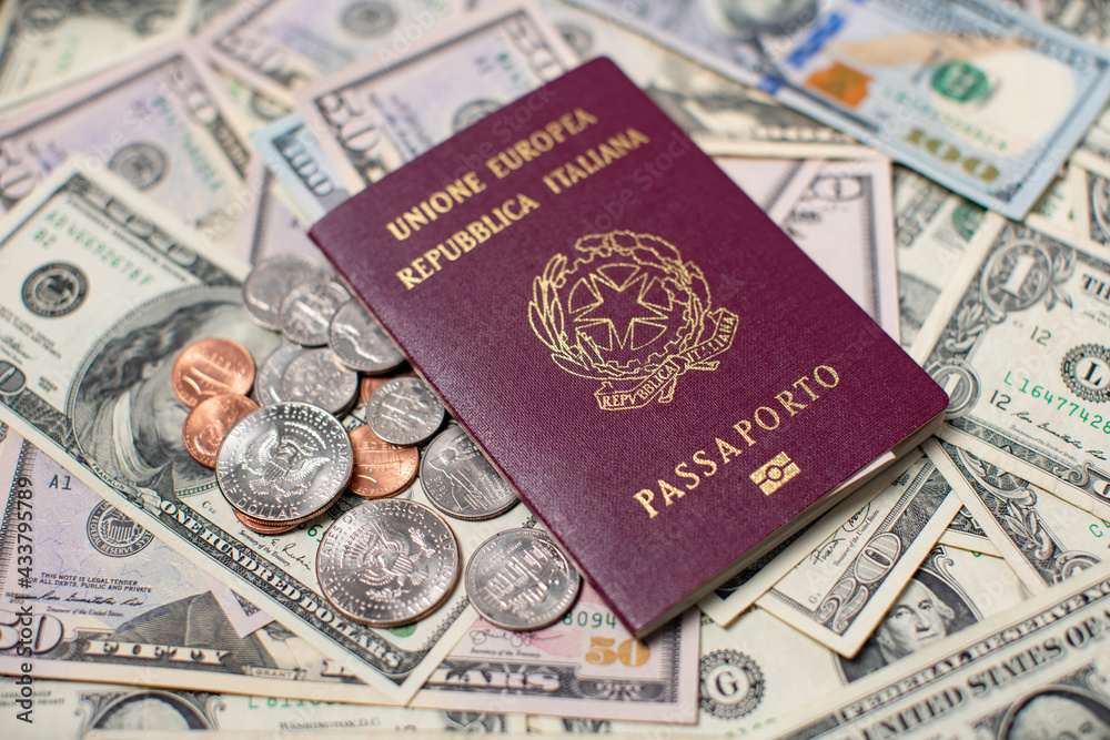 Italian Passport on top of US Dollar Banknotes and Coins. Travel to the
