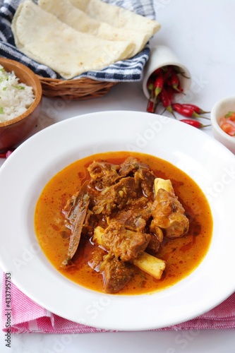 Shahi Mutton curry, Mutton masala, Mutton korma is a famous Spicy non-vegetarian dish of India. It's made out of Goat meat along with spices. Served with rice and roti. copy space.