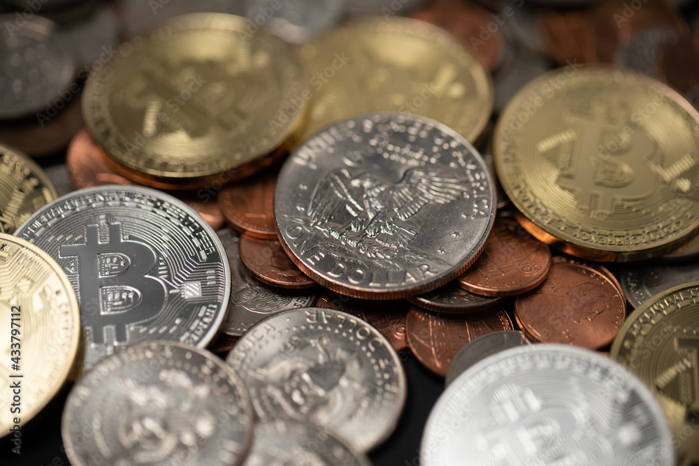 One dollar coin on top of pennies and golden Bitcoin coins. Crypto currency and dollar coins. Digital blockchain technology One dollar coin on top of pennies and golden Bitcoin coins. Crypto currency and dollar coins. Digital blockchain technology
