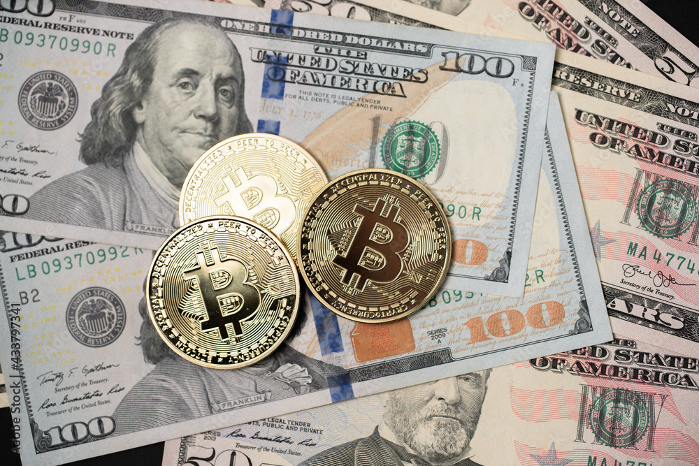Metal shiny bitcoin crypto currency coins on US dollar bills. Electronic decentralized money concept. Metal shiny bitcoin crypto currency coins on US dollar bills. Electronic decentralized money concept.