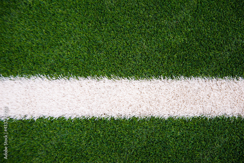 Photo of green grass and white line on football stadium