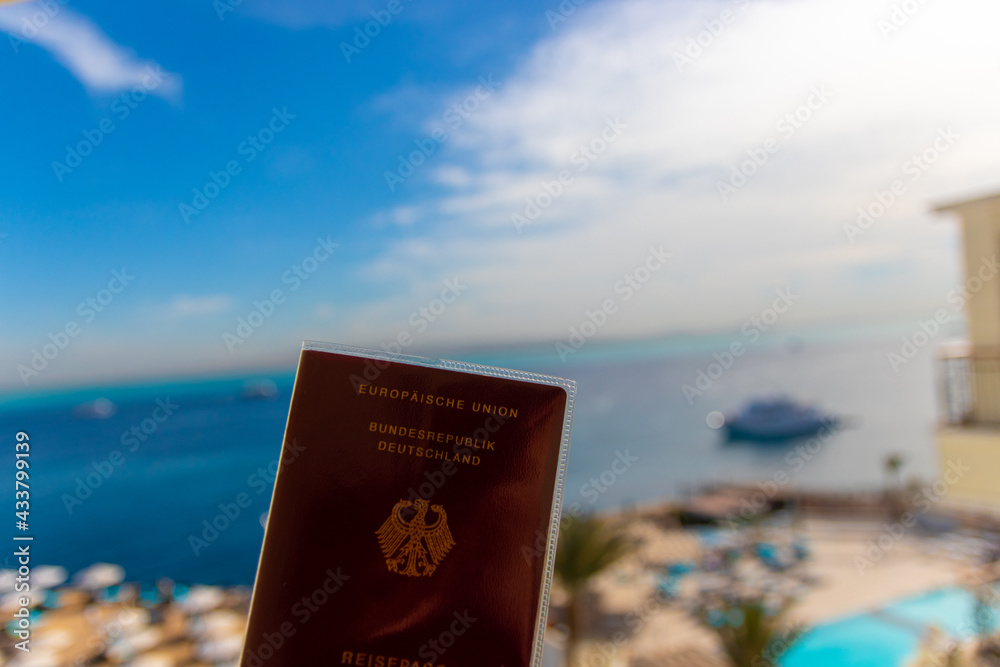 A passport against a blurred vacation background