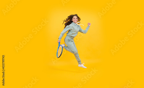 energetic child with tennis racquet. teen girl run to training. dedicated to fitness