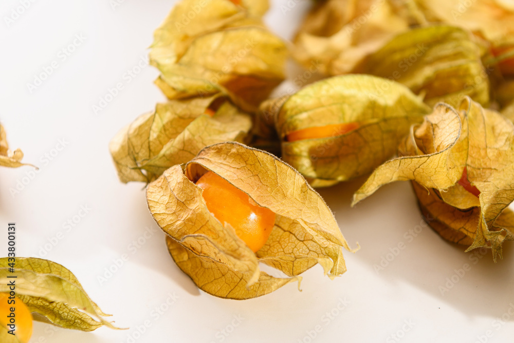 bright juicy yellow physalis berries close-up on a white background