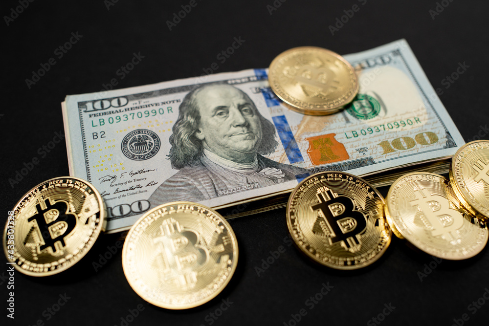 Piled up 100 Dollar Banknotes surrounded by Gold Bitcoin Coins. Digital Crypto Currency with US Dollar Currency.