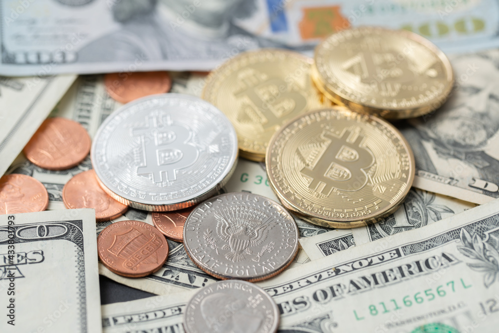 Silver and Gold Bitcoin on Dollar Banknotes and Coins. Digital Crypto currency with US Dollar Bills and pennies. Trading BTC with USD Silver and Gold Bitcoin on Dollar Banknotes and Coins. Digital Crypto currency with US Dollar Bills and pennies. Trading BTC with USD