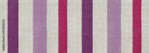 Fabric texture canvas. Cotton background. Detail close up for dress or other modern fashion textile print. Red, purple and gray striped textured design.