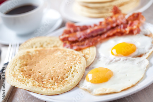 Fried Eggs with Pancakes and Bacon. High quality photo.
