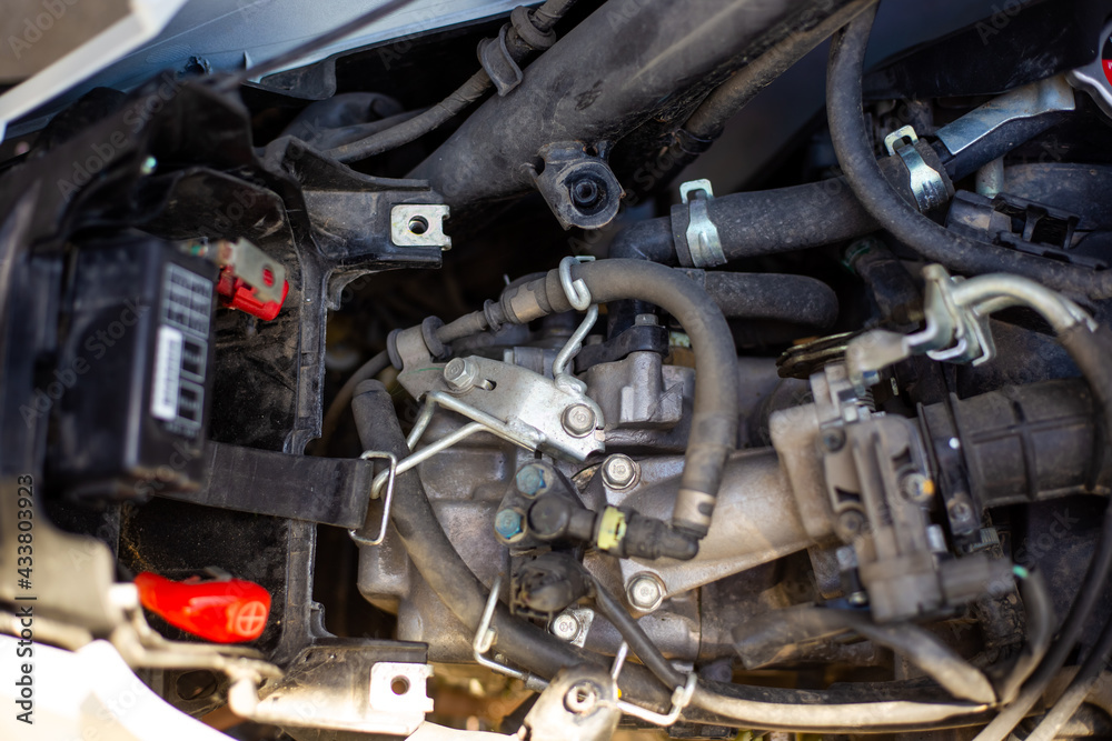 Repair and dismantling of a motorcycle. After removing the motorcycle seat, the engine is visible Repair and dismantling of a motorcycle. After removing the motorcycle seat, the engine is visible