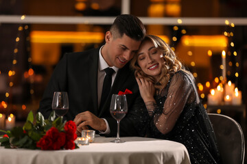 Lovely couple having romantic dinner on Valentine's day in restaurant
