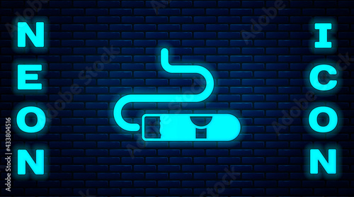 Glowing neon Cigar icon isolated on brick wall background. Vector