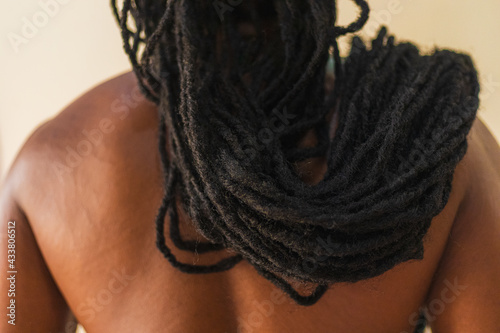 Man with dreadlocks draped around his shoulders.  photo