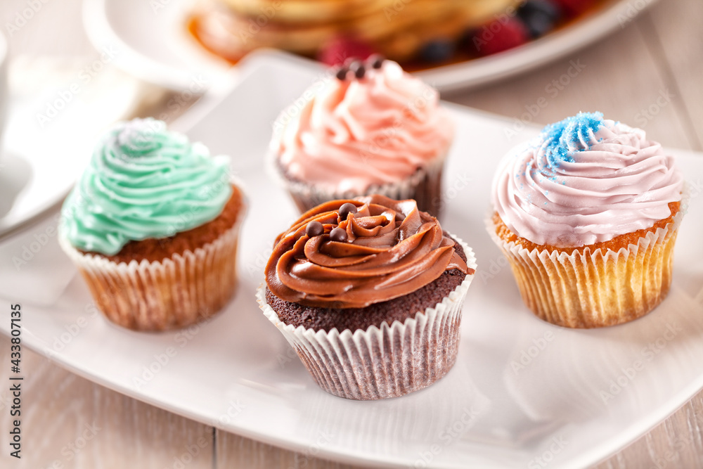 Selection of Colored Cupcakes on a Plate. High quality photo. Selection of Colored Cupcakes on a Plate. High quality photo.