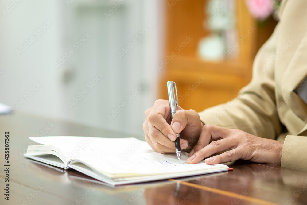Business people take notes with pen on notebook Business people take notes with pen on notebook