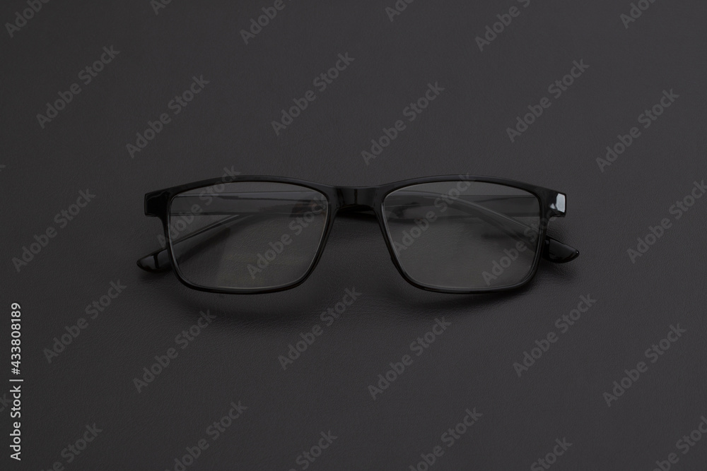Glasses for vision on a black background. Top view with copy space. Flat lay composition. Glasses for vision on a black background. Top view with copy space. Flat lay composition.