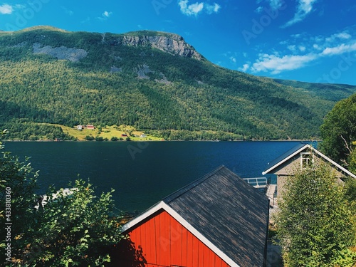 Nordic landscape, view of a fjord and mountains, horizon, blue sky