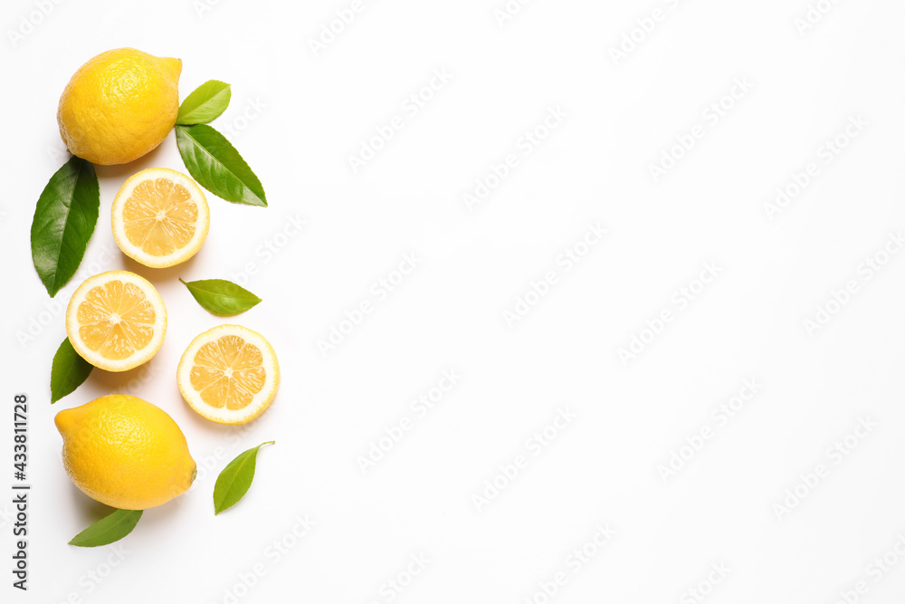 Flat lay composition with fresh juicy lemons and green leaves on white background. Space for text Flat lay composition with fresh juicy lemons and green leaves on white background. Space for text