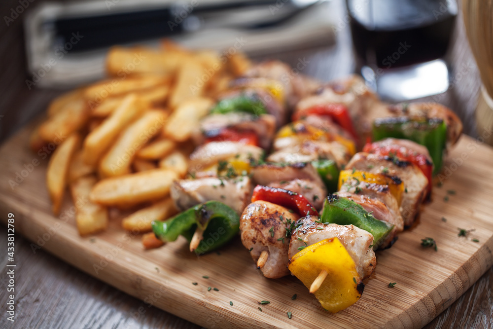 Chicken skewers with fries. High quality photo. Chicken skewers with fries. High quality photo.