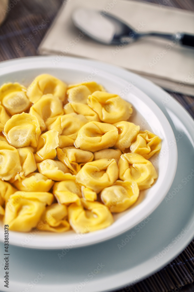 Italian Tortellini In broth on a plate. Italian Tortellini In broth on a plate.
