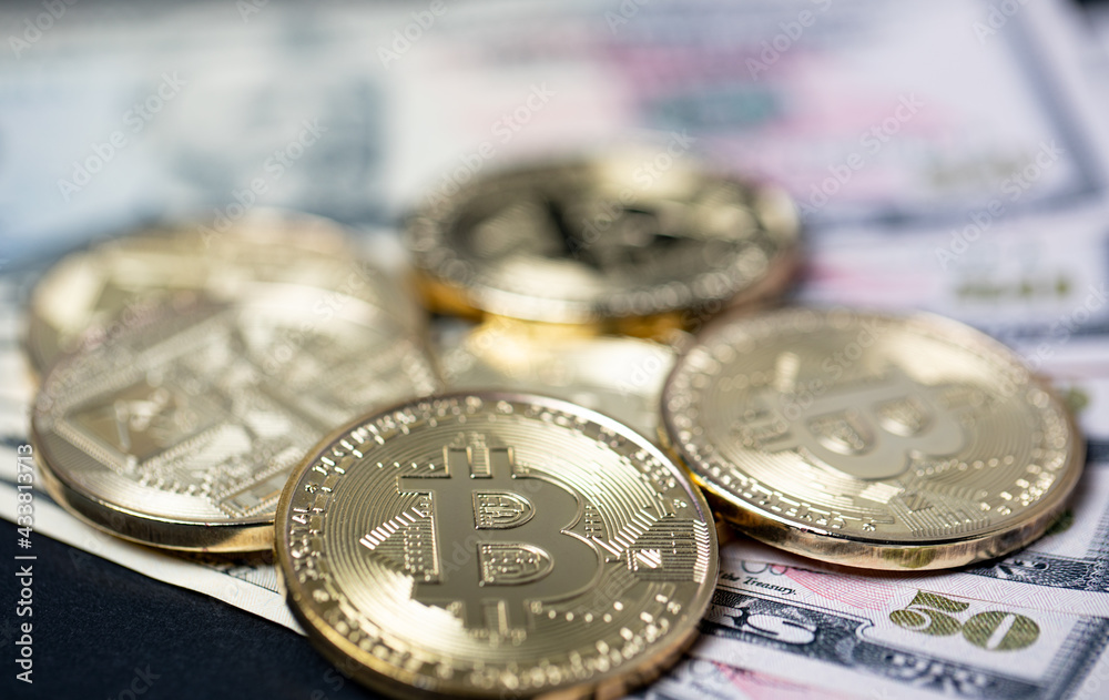 Bitcoin gold coins on fifty dollar banknotes. Exchange dollar to bitcoin crypto currency concept Bitcoin gold coins on fifty dollar banknotes. Exchange dollar to bitcoin crypto currency concept